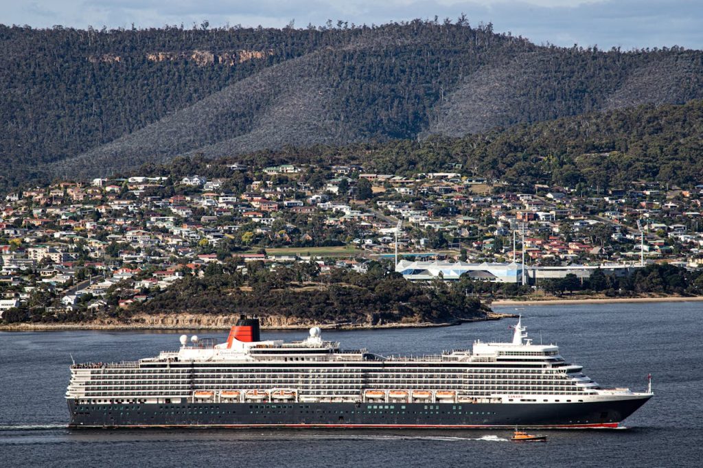 Aerial view of a cruise ship sailing near the coastal city of Hobart, Tasmania, Australia.